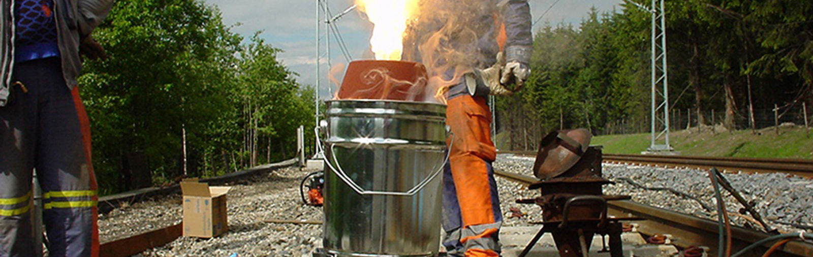 Thermit-reaksjon ved skjøtsveising av skinner, med kraftig flamme over digelen.